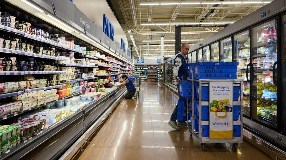 Workers stand in an aisle at an Ohio Walmart store.