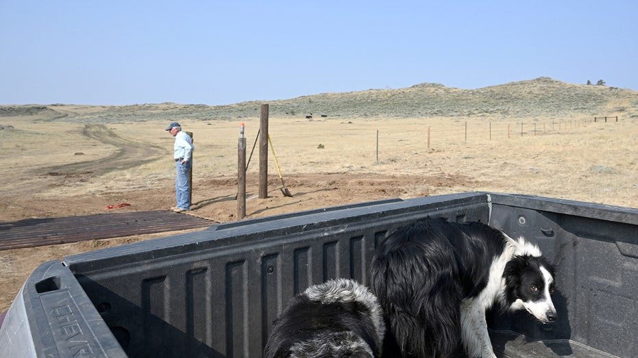 A ranch owner speaks with a worker during a visit to his expansive property outside Cheyenne, Wyoming.