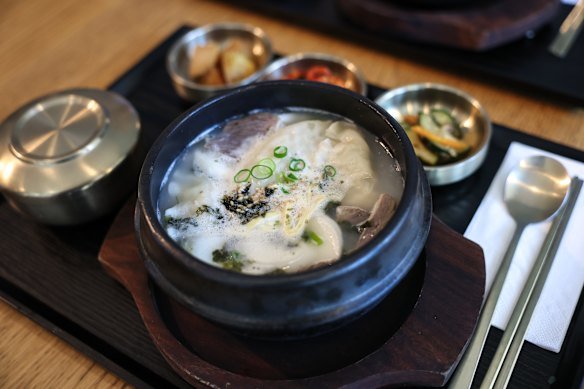 Tteok mandu guk (rice cake, dumpling and beef bone stock) at Misty Pot restaurant.