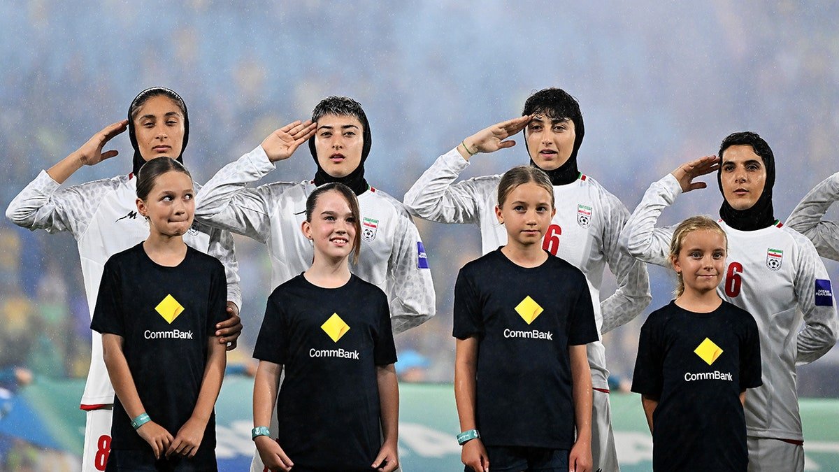 Iranian women's soccer team salute national anthem