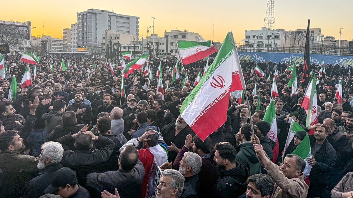 Thousands of people gather in a central Tehran square following a major announcement broadcast on state television.