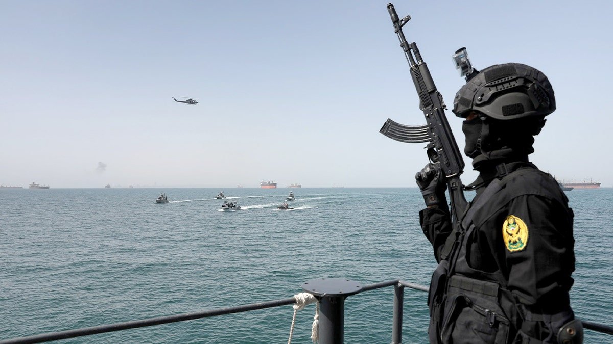 Warships maneuver off the coast of southern Iran during a joint maritime exercise.