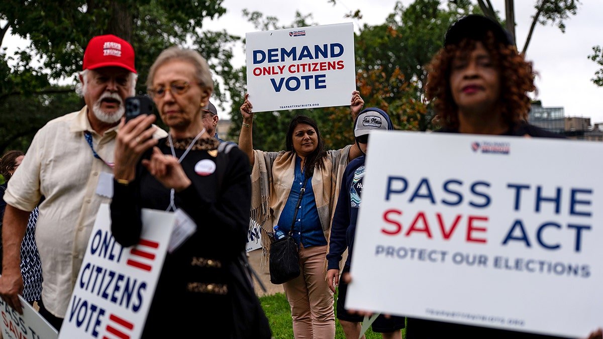 People with signs supporting the SAVE act at Upper Senate Park