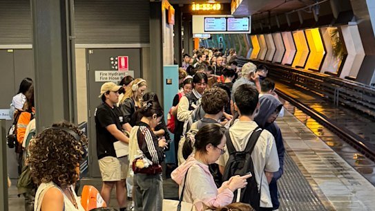 Commuters waiting at Chatswood station during the storm.