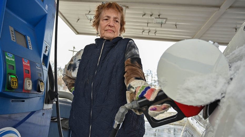 Customer Jann Gregg of Schenectady pumps gas at the GasWay Xpress Mart.