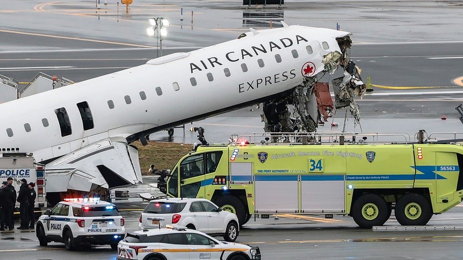 An Air Canada Express CRJ-900 airplane sitting on a runway at LaGuardia Airport after a collision.