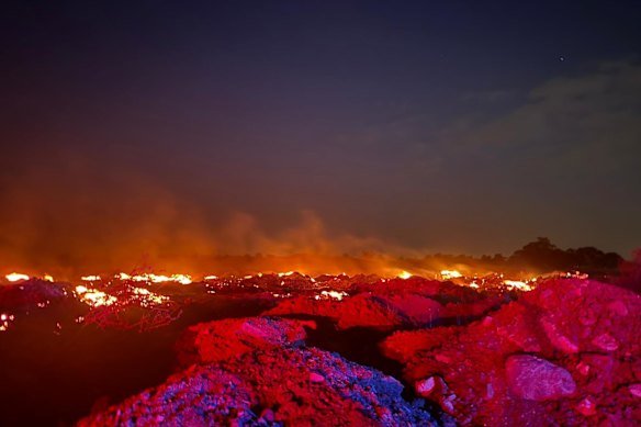 A fire at the Summerhill Road property lights up the night sky.