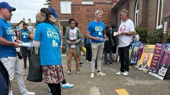 Gareth Hales (centre, in blue Scott Yung T-shirt), the son of the Brethren’s world leader, Bruce Hales, at the Bennelong polling booth in Sydney on April 30.