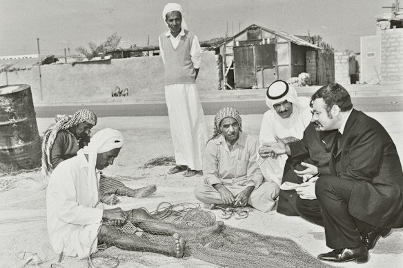 In 1976, a palace official speaks with fishermen on a beach in Umm Al Quwain, one of the UAE’s seven emirates.