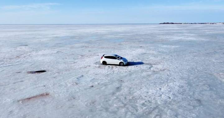 Abandoned car retrieved from ice off Nova Scotia shore by helicopter, snowmobiles Abandoned car retrieved from ice off Nova Scotia shore by helicopter, snowmobiles