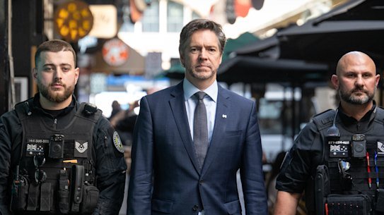 Lord Mayor Nick Reece flanked by security guards in March.