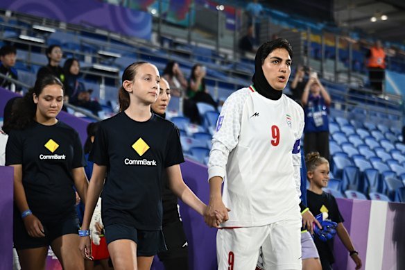 Captain Zahra Ghanbari leads Iran out for their Asian Cup match against South Korea on March 2.