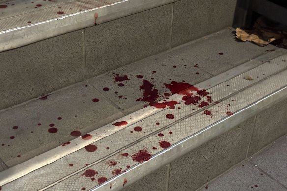 Blood spattered on the stairs of a nearby building