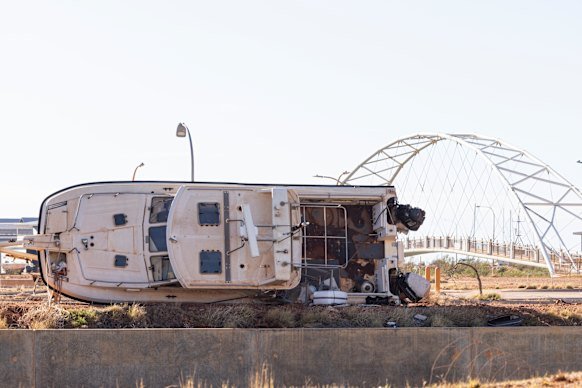 A boat lies on its side in Exmouth after the town was struck by Tropical Cyclone Narelle on the weekend.