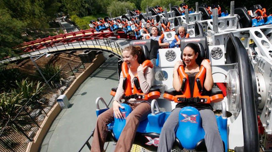 Riders on a Six Flags roller coaster in California.