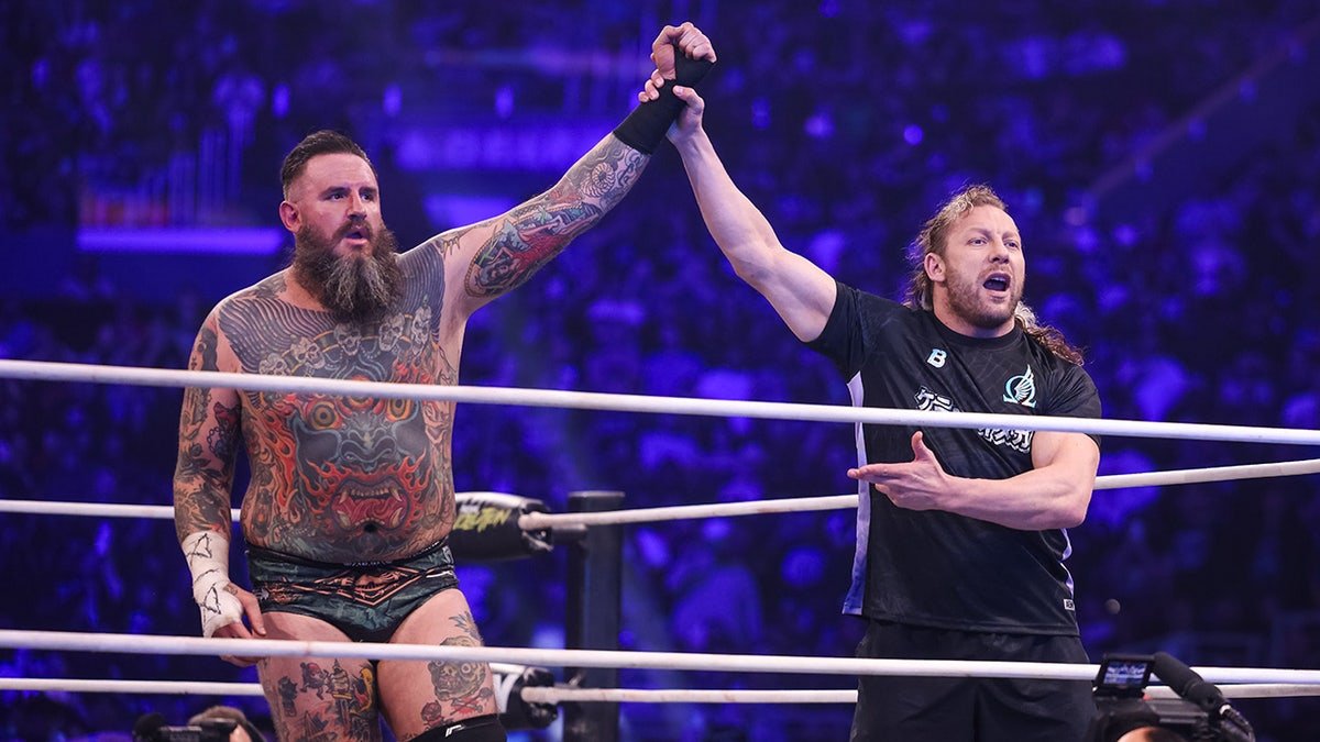 Kenny Omega raises the hand of Brody King