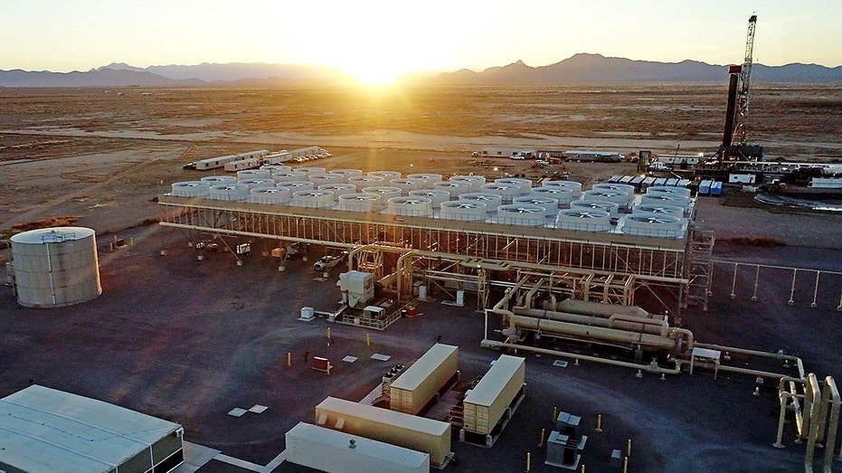 Machinery and equipment with sun in the background.