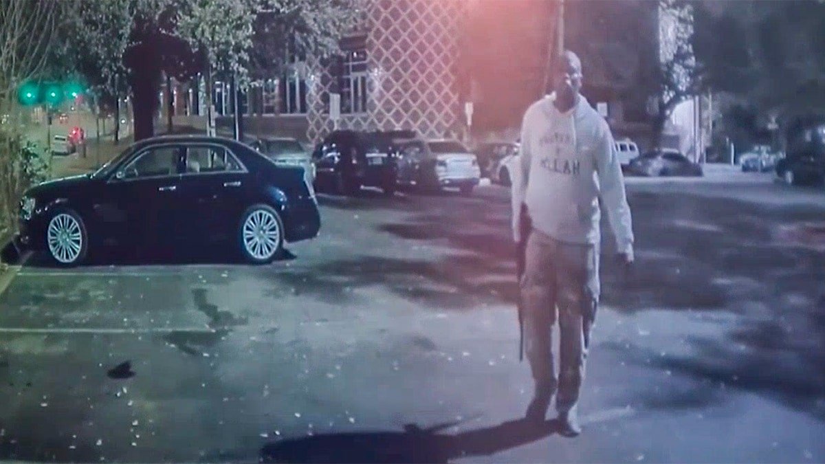 Shooter walking in the parking lot.