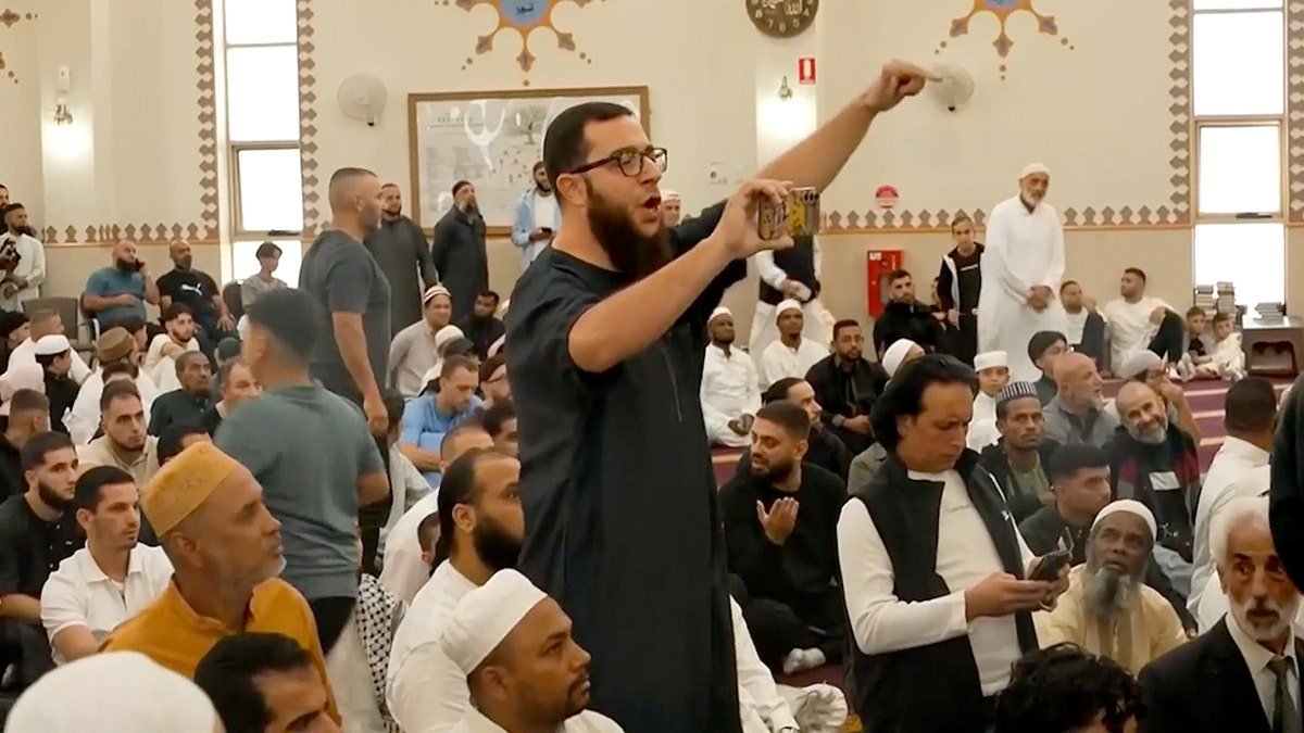 A man standing and pointing a finger at Albanese