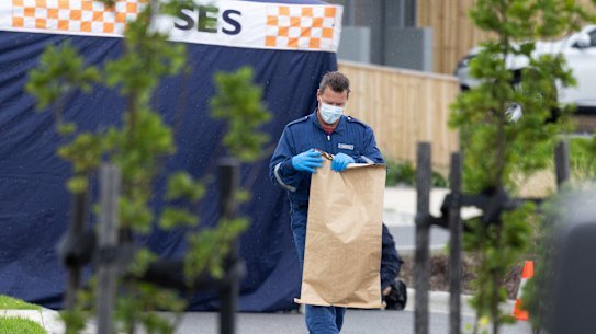 A forensic officer bags up evidence at the Donnybrook home.