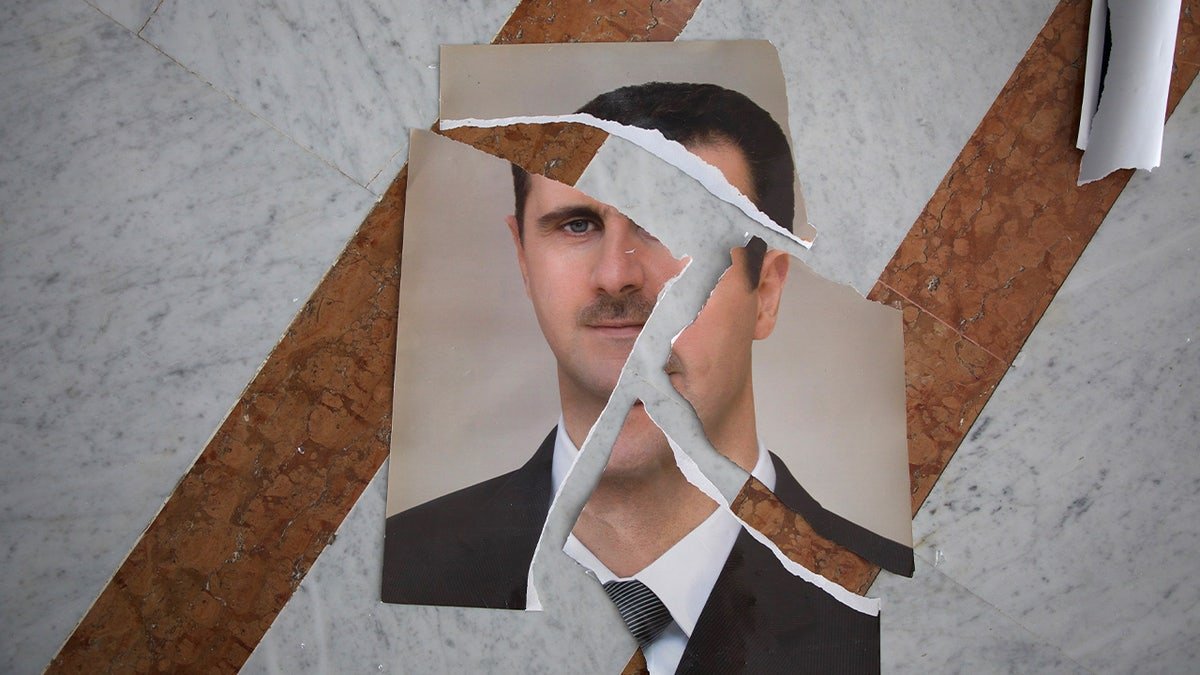 A ripped portrait of Syrian President Bashar al-Assad.