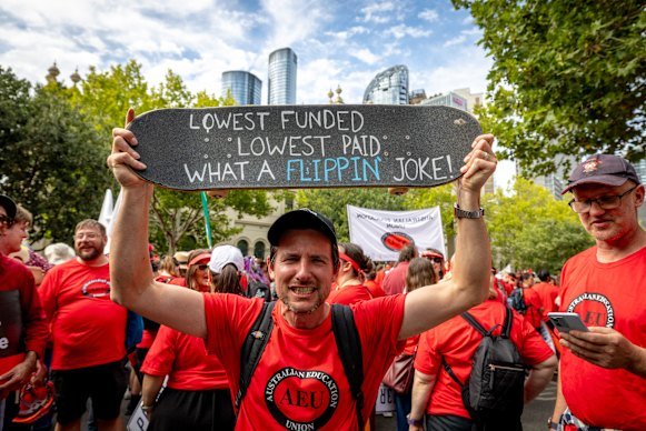 An educator protests in Melbourne’s CBD on Tuesday during the mass AEU strike rally.