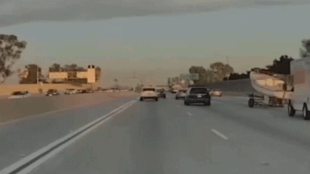 Boat trailer crashes over center median on busy California freeway, driver doesn’t stop