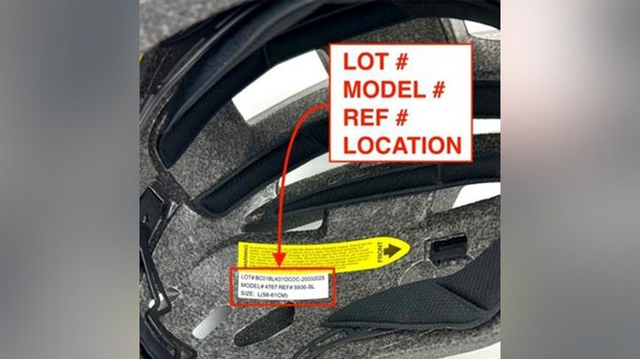 A graphic that reads "LOT #, MODEL #, REF #, LOCATION" points to a tag inside of a black bicycle helmet.