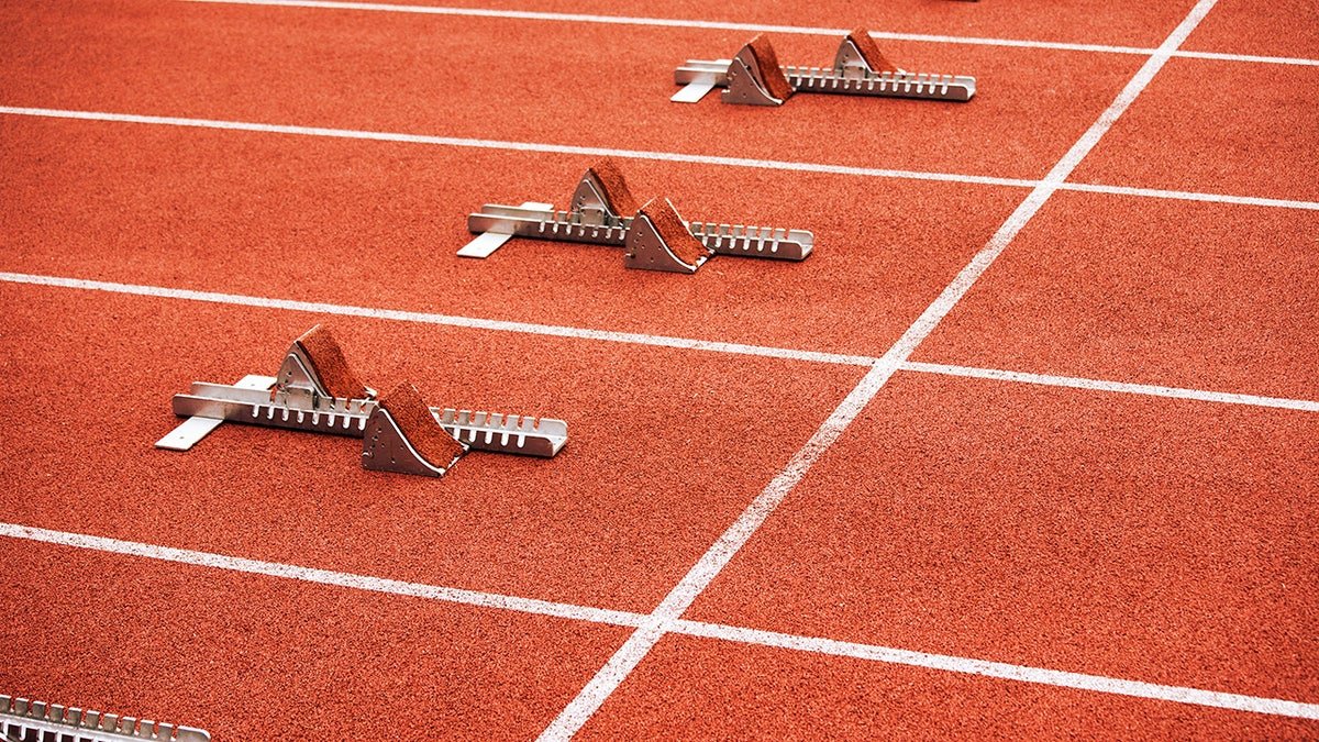 Five empty starting blocks on stadium