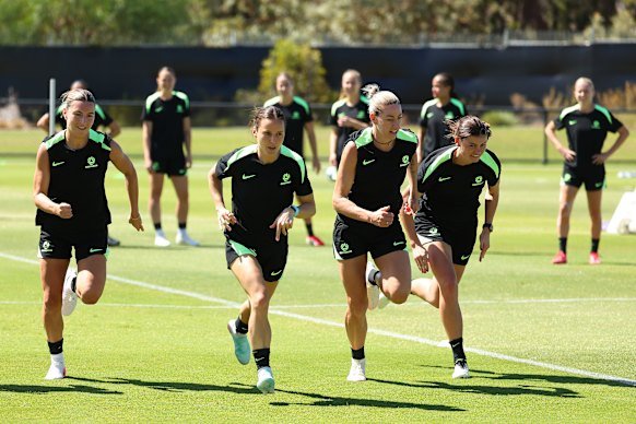 The Matildas warm up during training in Perth.