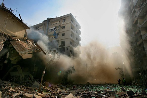 On her first visit to Lebanon in 2006,  Kate Geraghty took this photo of two men  running through the rubble after Israeli drones were heard in Dahia, a southern suburb of Beirut. The shops and apartment buildings in the background were hit by about seven  Israeli bombs at 5am, August 7. 