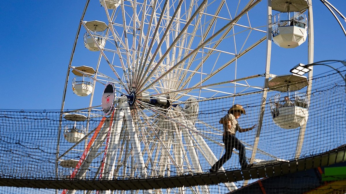 Person walks on Houston Livestock Show and Rodeo obstacle course