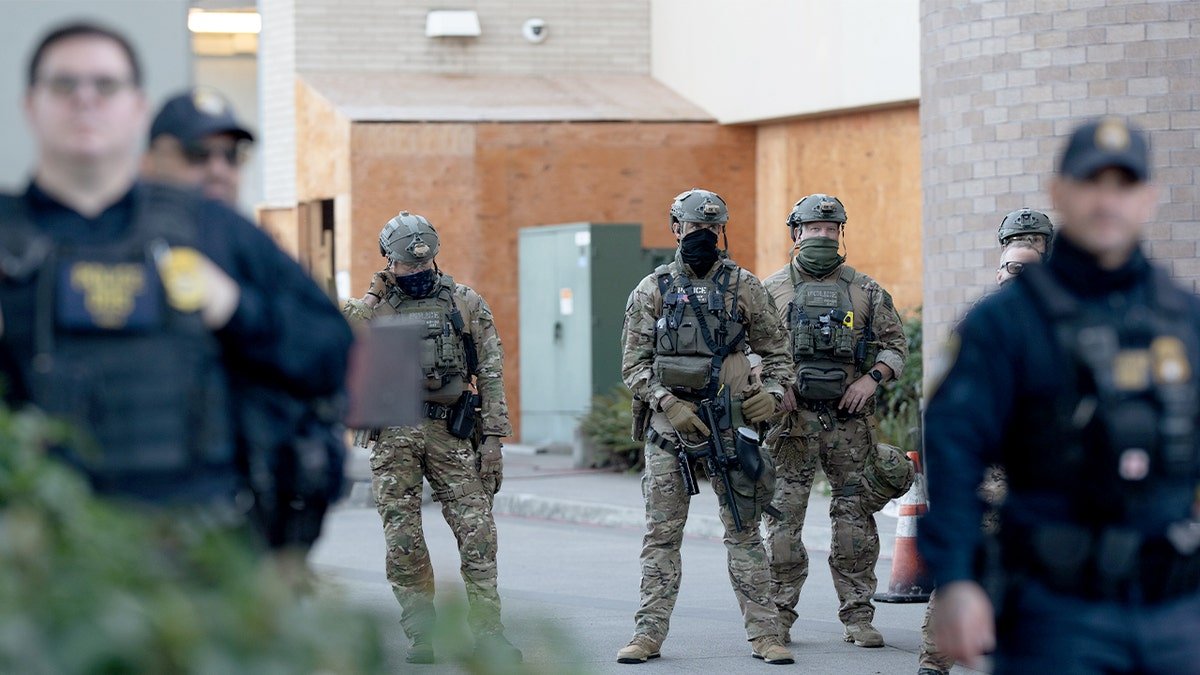 Officers stand inside a federal building in Oregon.