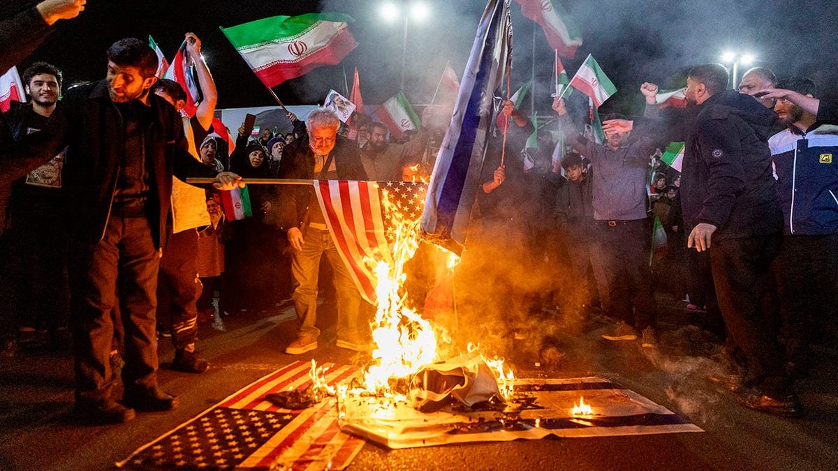 Iranians burning an American flag