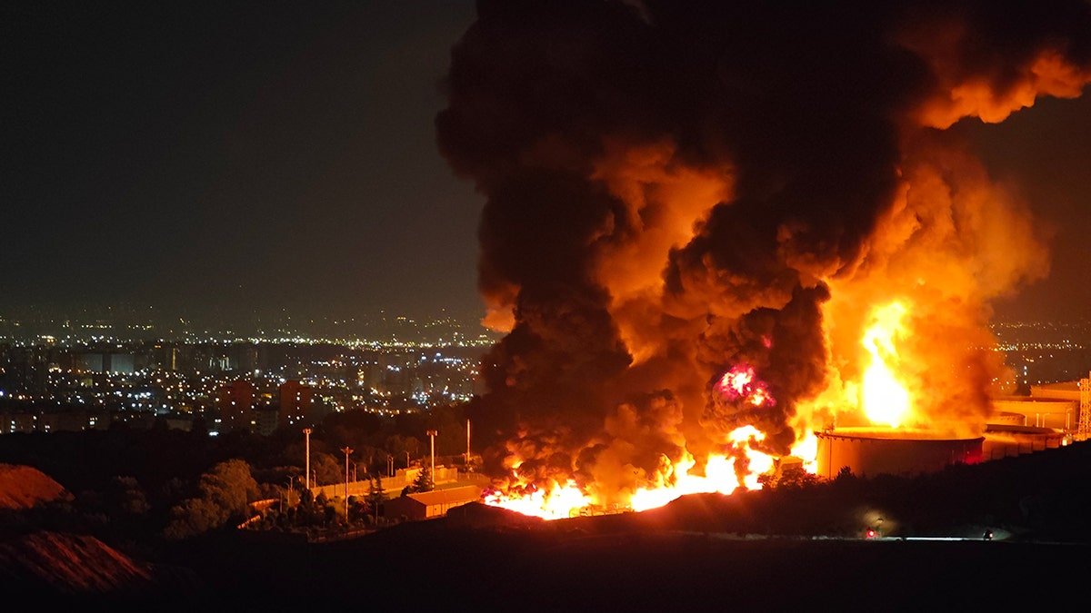Fire and smoke rise from an Iranian oil depot