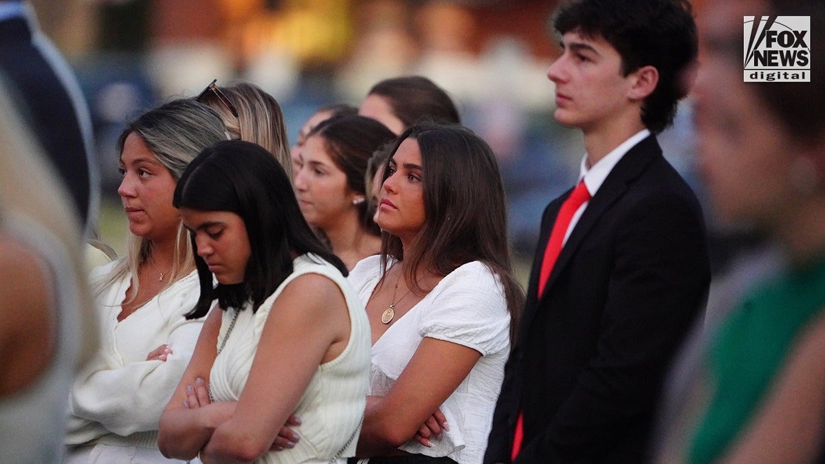 Mourners at a memorial vigil for Jimmy Gracey standing together