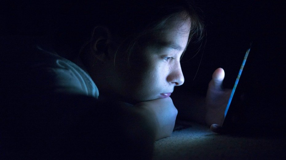 Kid on mobile phone.