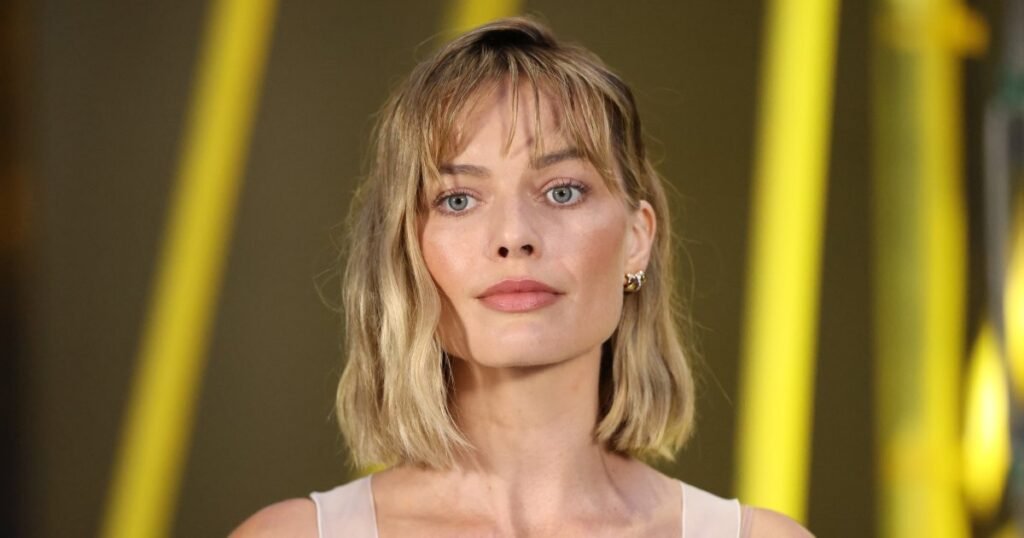 Margot Robbie’s Wine-Red Airport Tote Is the Perfect Travel Carryall — Get the Look