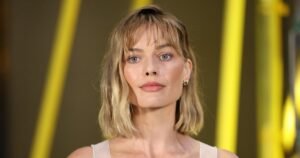 Margot Robbie’s Wine-Red Airport Tote Is the Perfect Travel Carryall — Get the Look