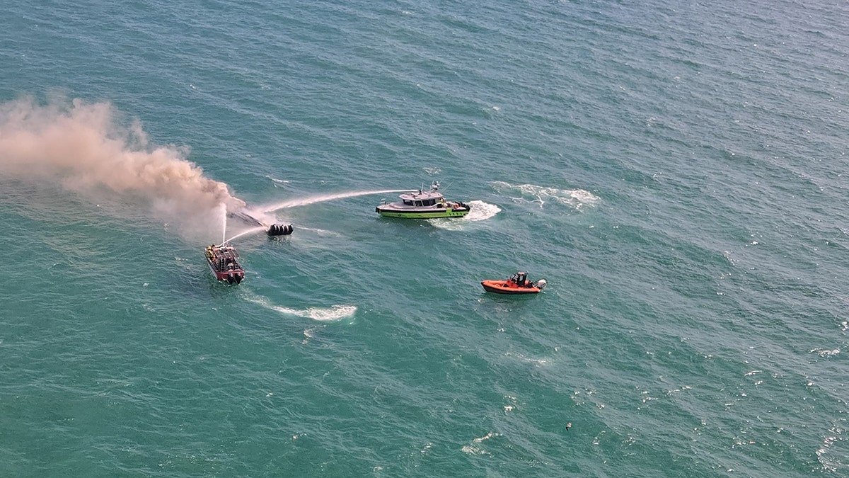 A tourist boat goes up in flames off the coast of Miami Beach, Florida