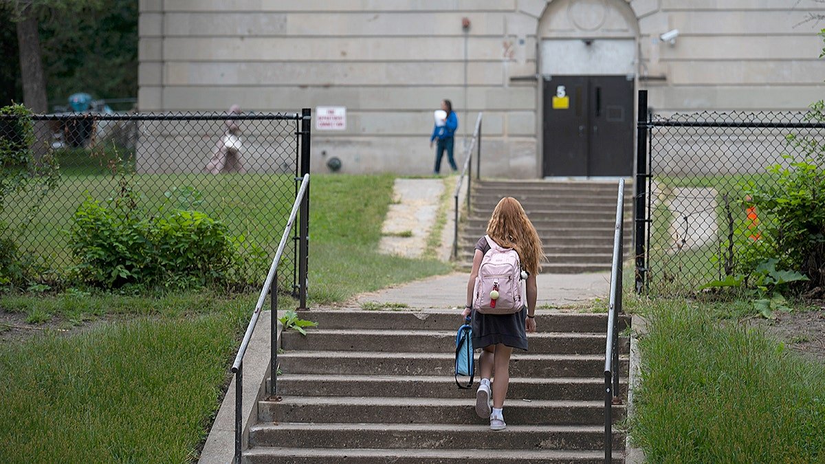 A student walks into a public school in Minnesota