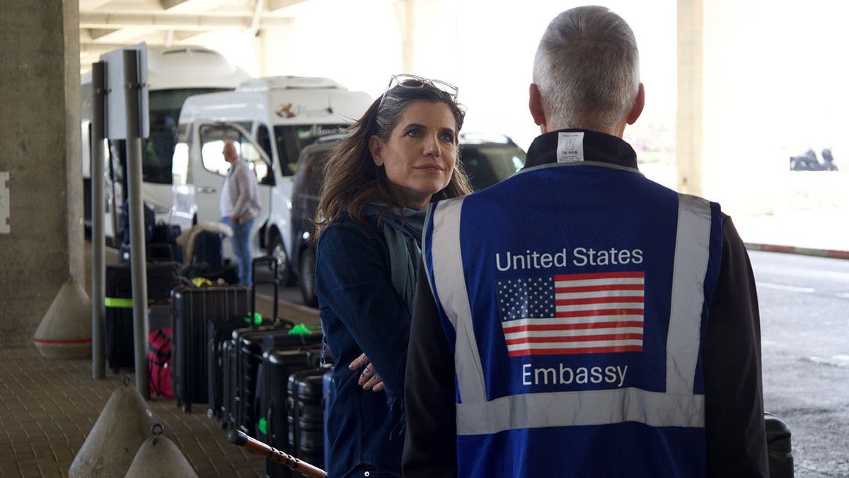 Mace talking with U.S. Embassy worker