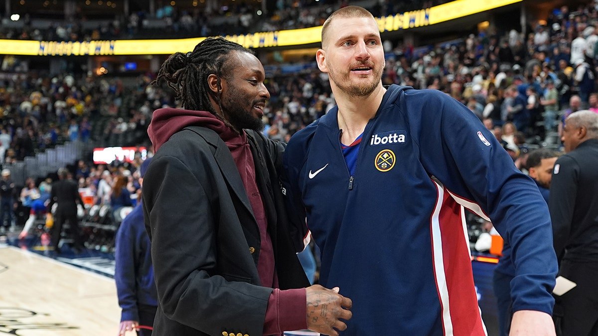 Nikola Jokic greets a player