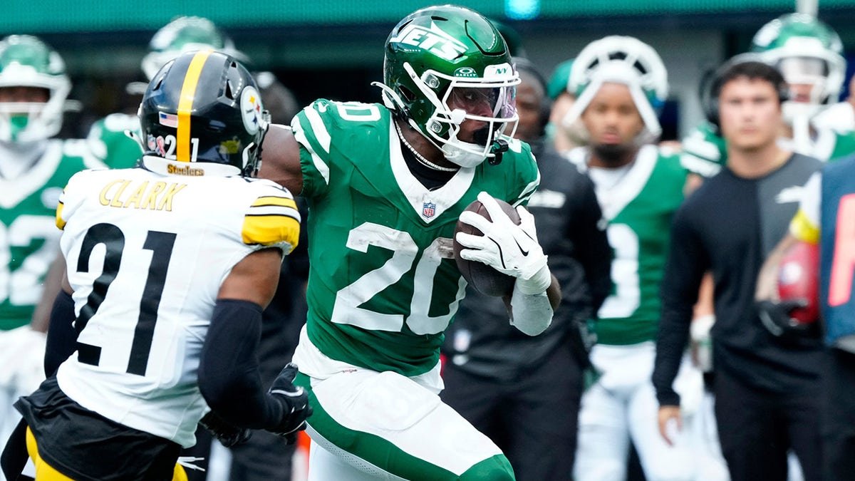 Breece Hall runs up the sideline