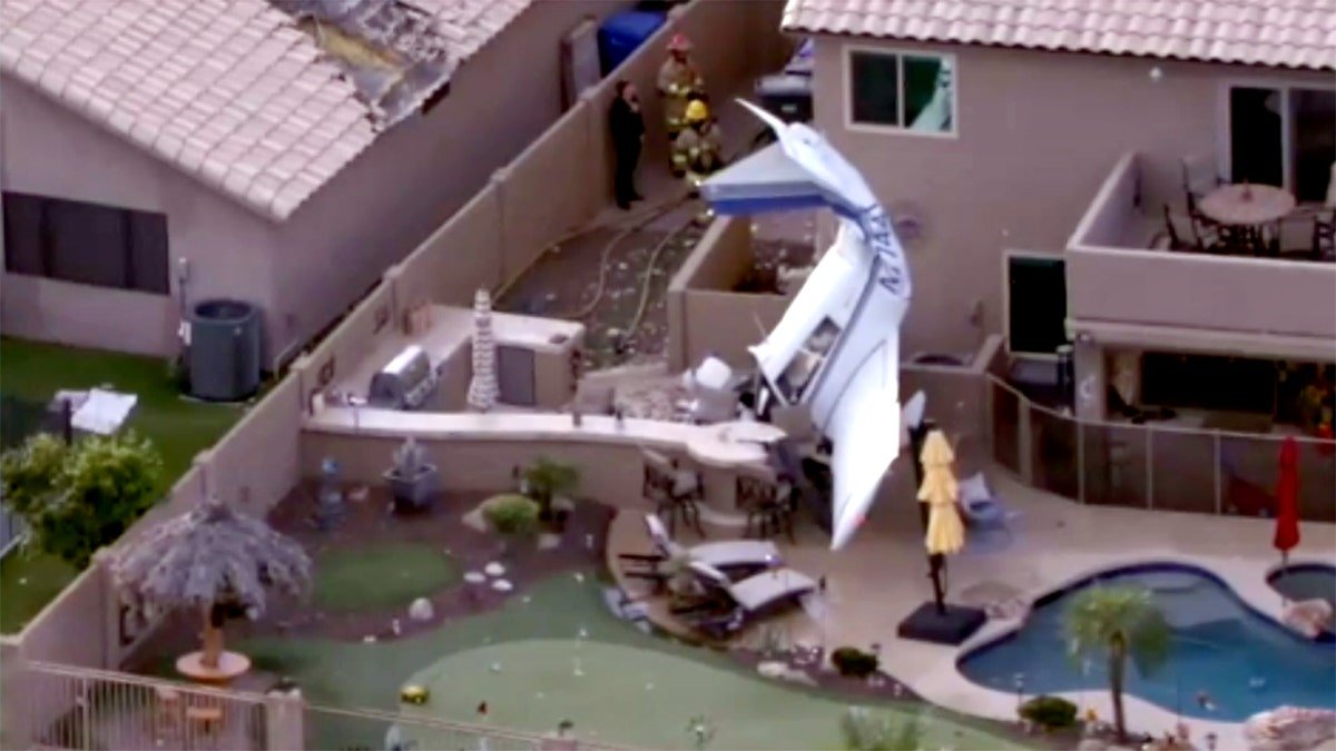 small plane wreckage in residential backyard