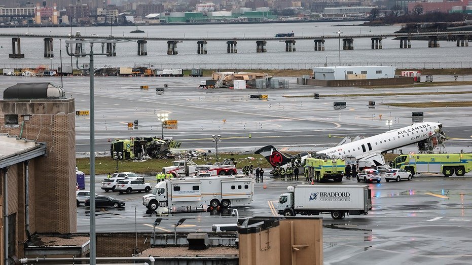 An Air Canada Express CRJ-900 airplane sitting on a runway at LaGuardia Airport after a collision.