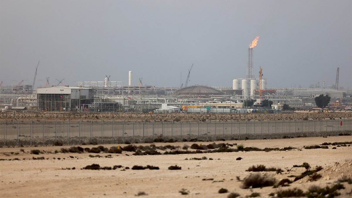 Industrial energy infrastructure with processing units and storage tanks at a major Qatari gas complex following a production shutdown.