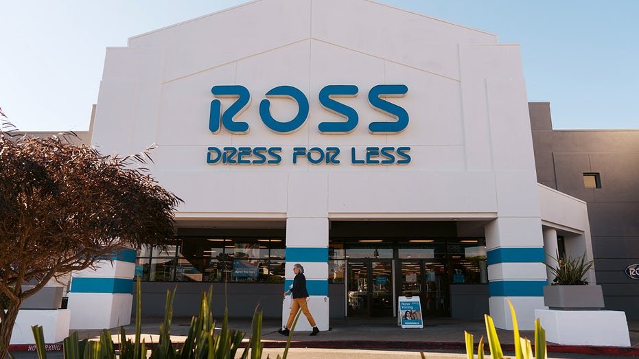 A person walking in front of a Ross store in San Francisco, California.