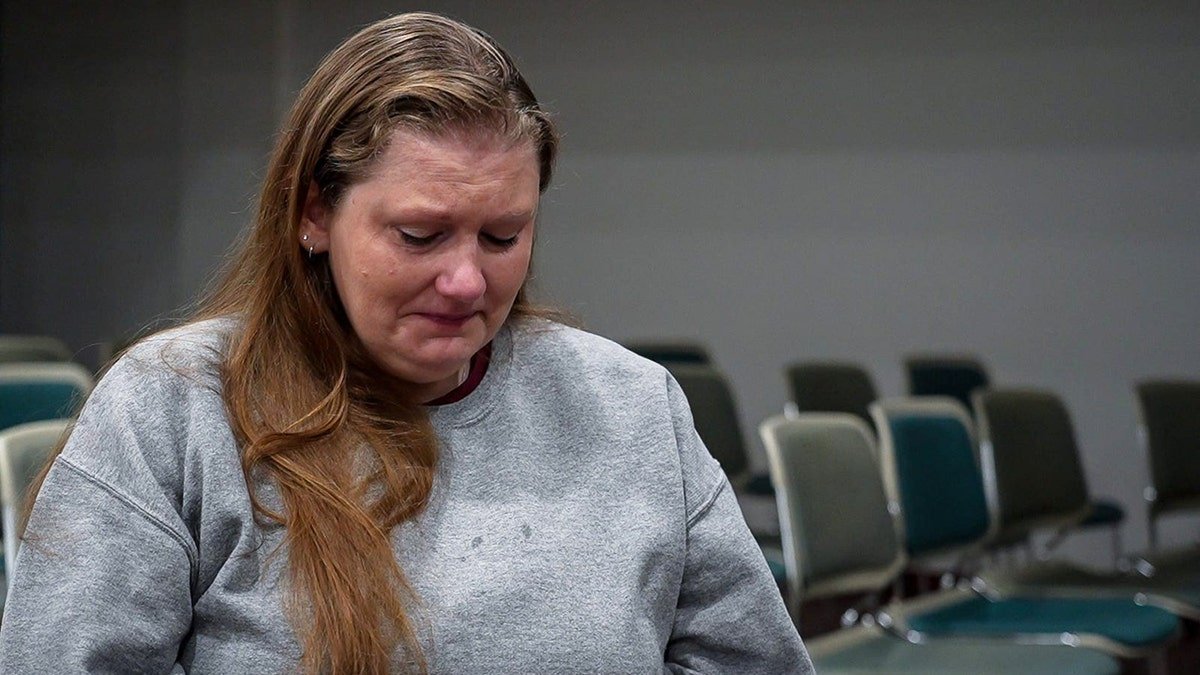 Sarah Pender looking down and crying.