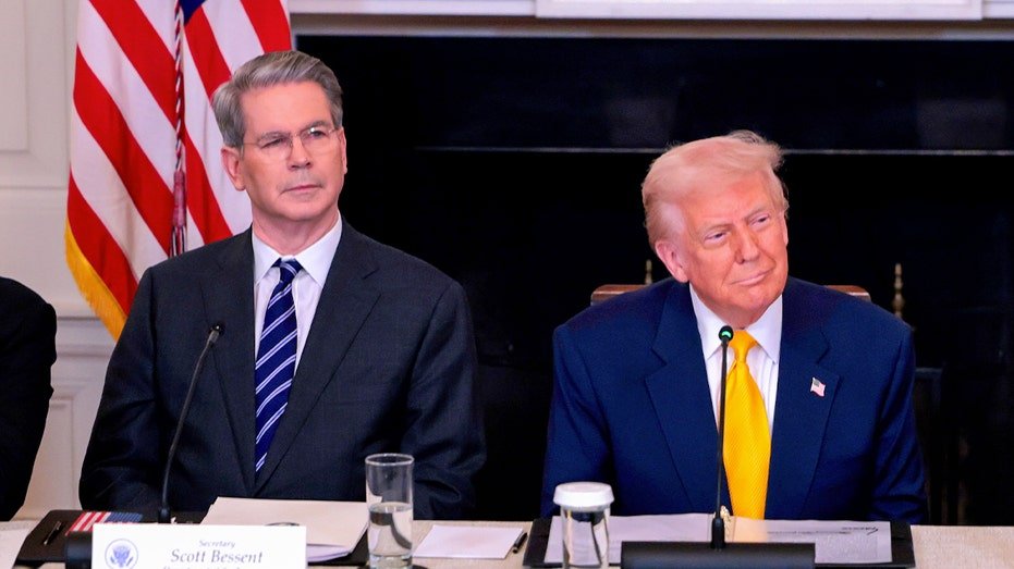 Scott Bessent sits next to Donald Trump